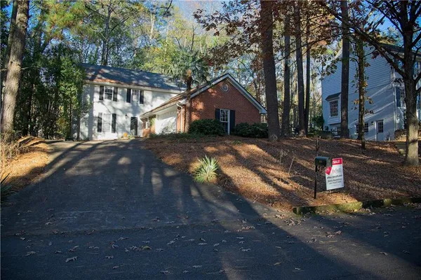 front view of a house with a large trees