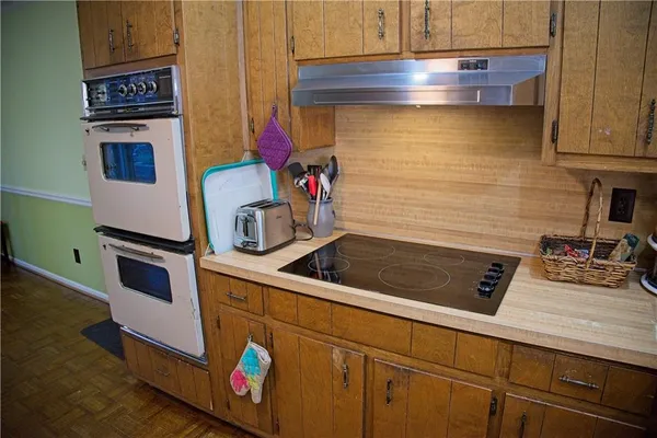 a kitchen with stainless steel appliances granite countertop a sink stove and cabinets