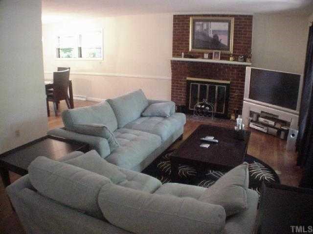 1804 Manuel Street Raleigh, NC 27612 - Photo 2 of 7 Living Room with hardwoods and wood-burning fireplace.