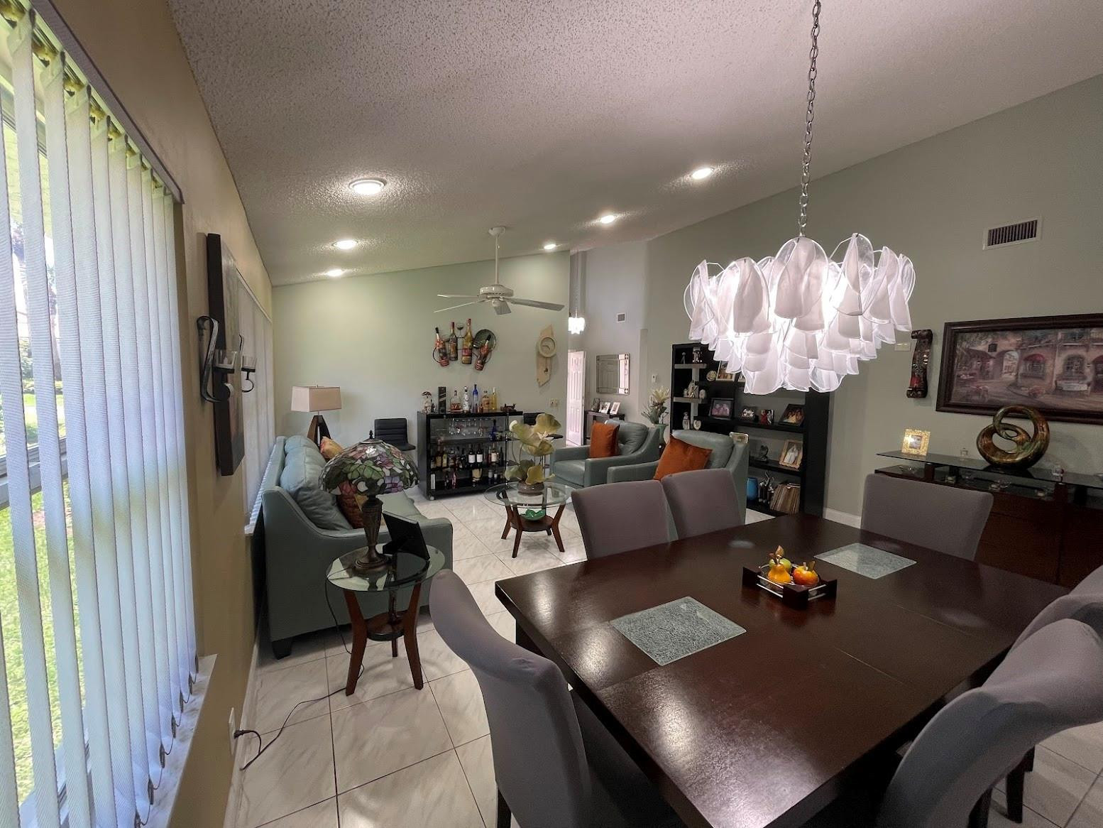 11088 Rios Road Boca Raton, FL 33498 - Photo 10 of 37 a living room with lots of furniture and a chandelier