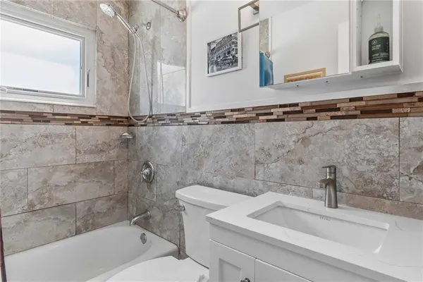 a bathroom with a sink a toilet and bathtub