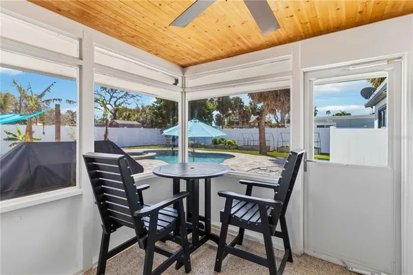 a view of a dining room with furniture large windows and wooden floor