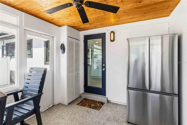 a view of kitchen with furniture and refrigerator