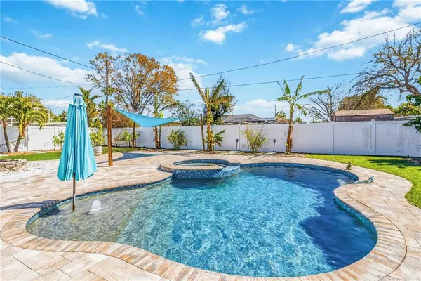 a view of a house with a swimming pool and a yard