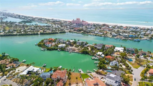 an aerial view of residential houses with outdoor space and parking