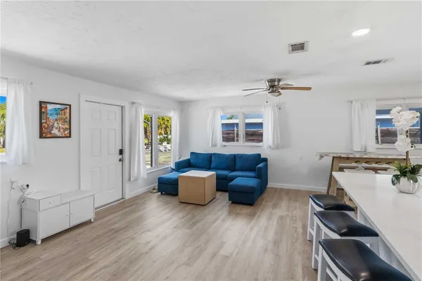 a living room with furniture and wooden floor