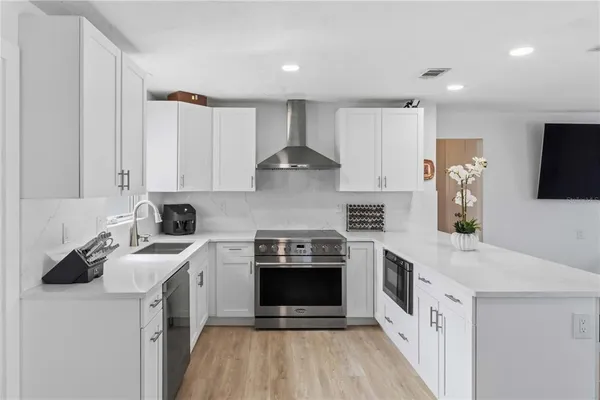 a kitchen with stainless steel appliances granite countertop a stove and a sink