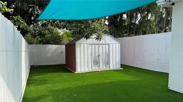 a view of a backyard with a small cabin