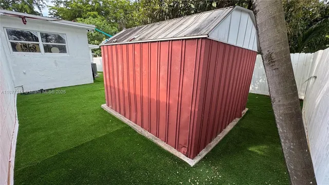 a view of a backyard with wooden fence
