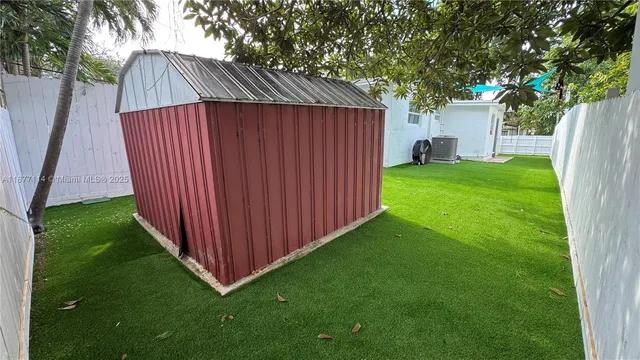 a view of a backyard with a cabin