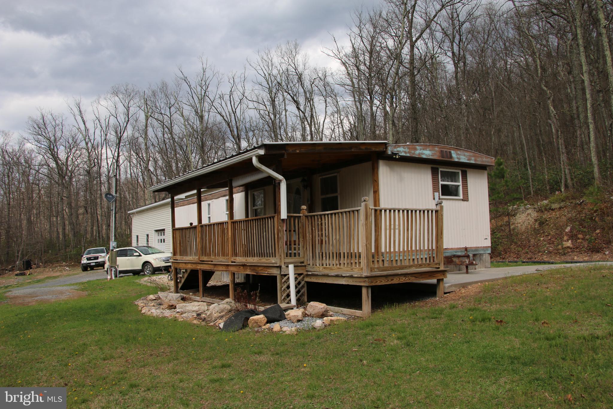 680 Sawlog Road Gore, VA 22637 - Photo 2 of 47 a small house with wooden fence and trees