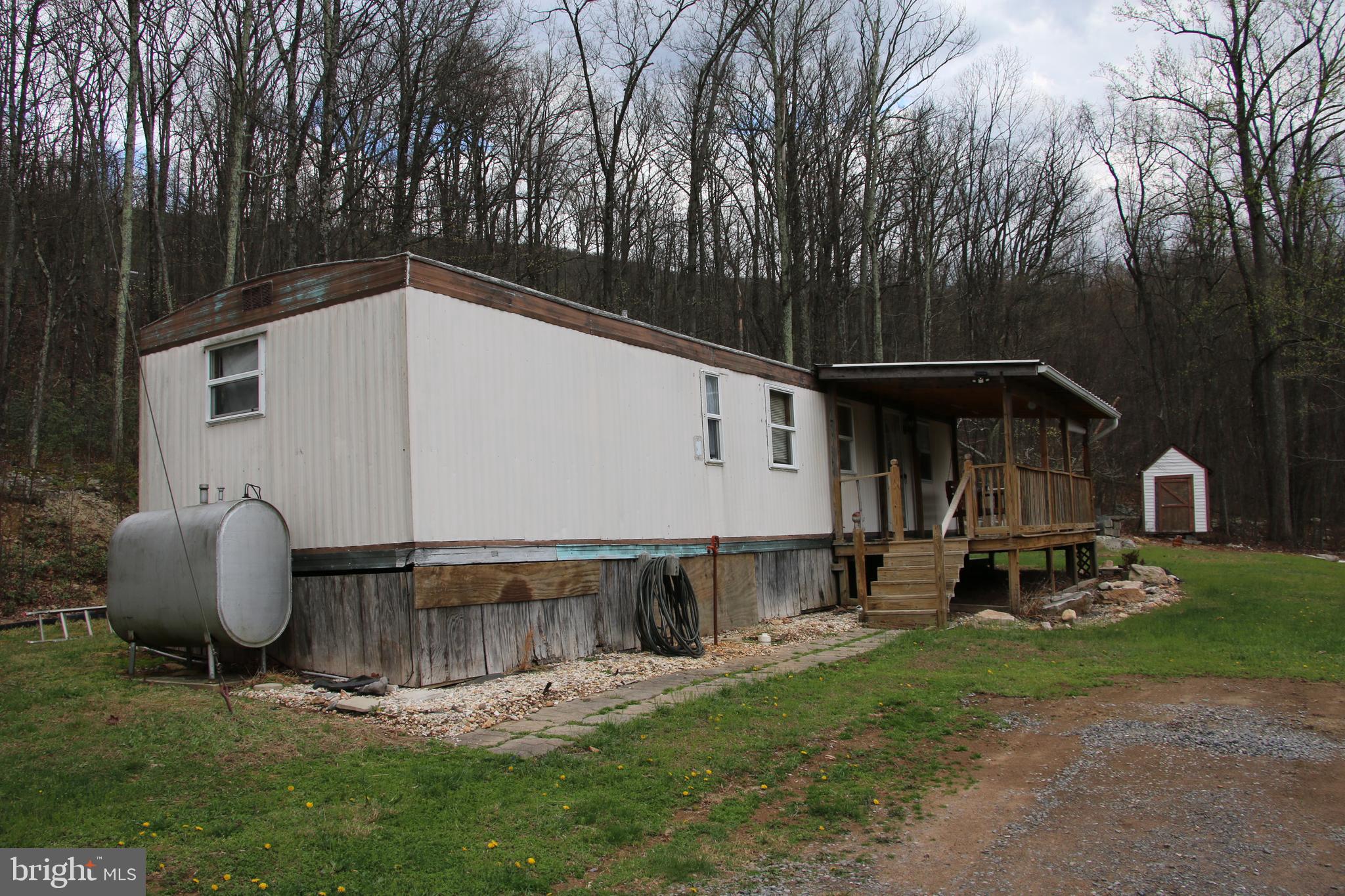 680 Sawlog Road Gore, VA 22637 - Photo 3 of 47 a backyard of a house with barbeque oven and outdoor seating