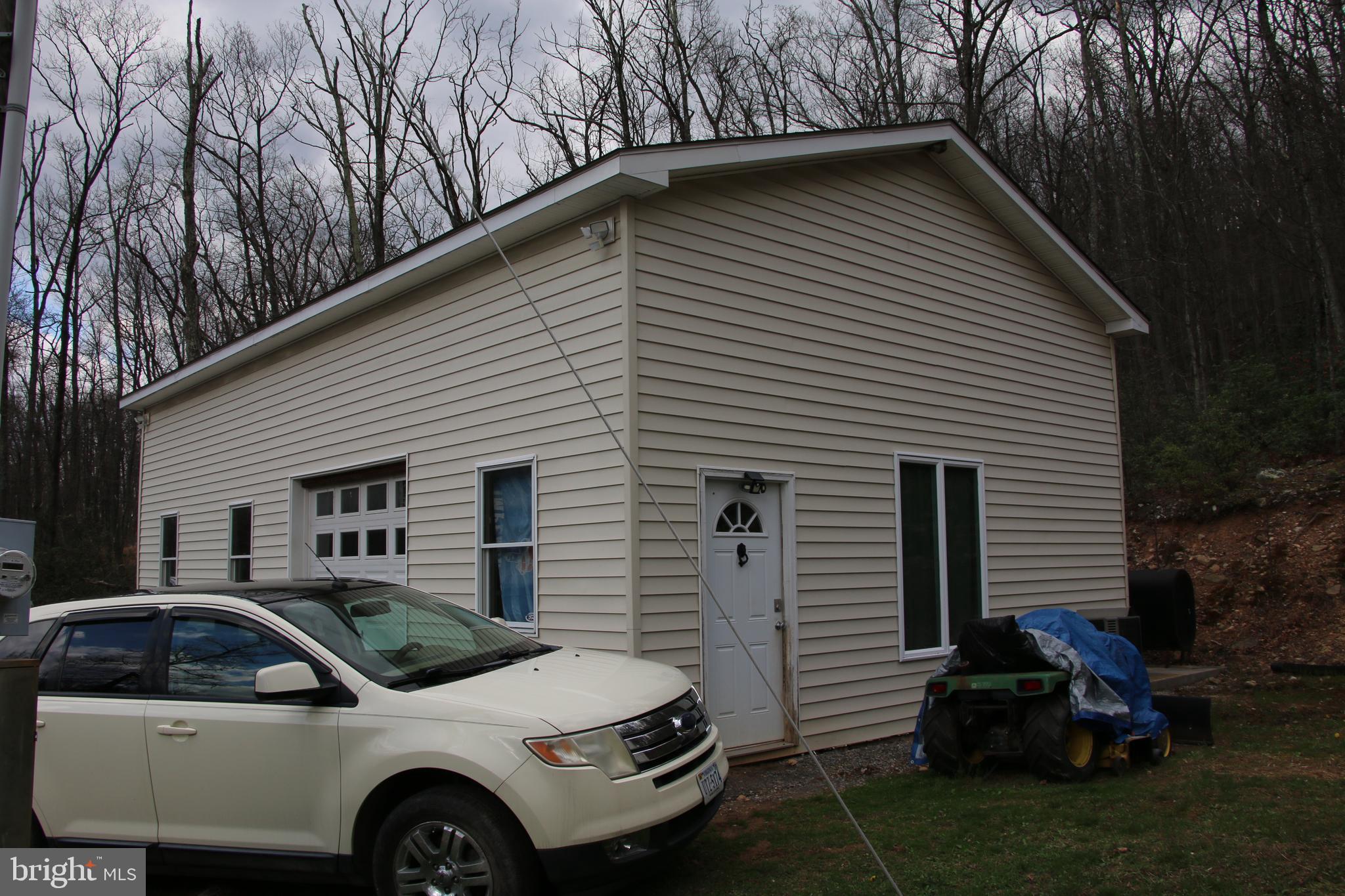 680 Sawlog Road Gore, VA 22637 - Photo 4 of 47 a front view of a house with a garden