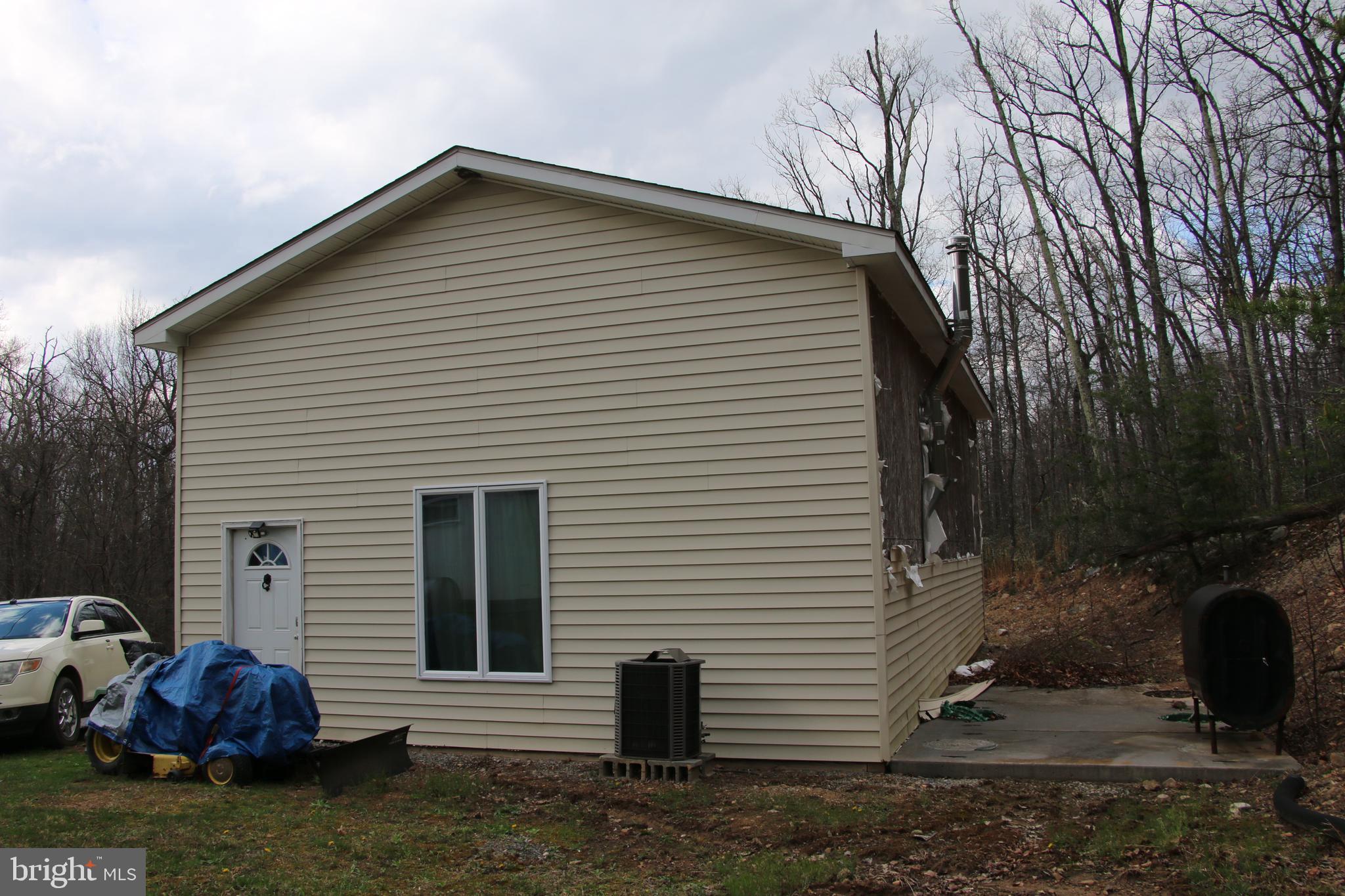 680 Sawlog Road Gore, VA 22637 - Photo 6 of 47 a front view of a house with garden