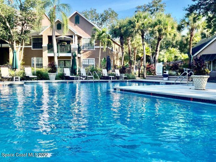 7667 North Wickham Road, Unit 715 Melbourne, FL 32940 - Photo 4 of 13 a view of a building with a swimming pool and sitting area