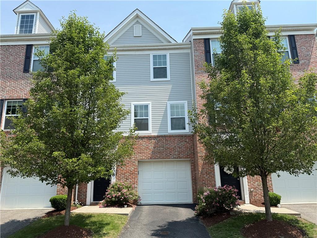 108 Watson Drive Warrendale, PA 15086 - Photo 1 of 31 a front view of a house with a yard and a garage