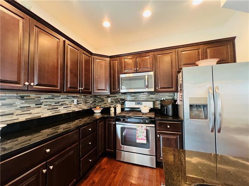 108 Watson Drive Warrendale, PA 15086 - Photo 11 of 31 a kitchen with stainless steel appliances a stove cabinets and a refrigerator