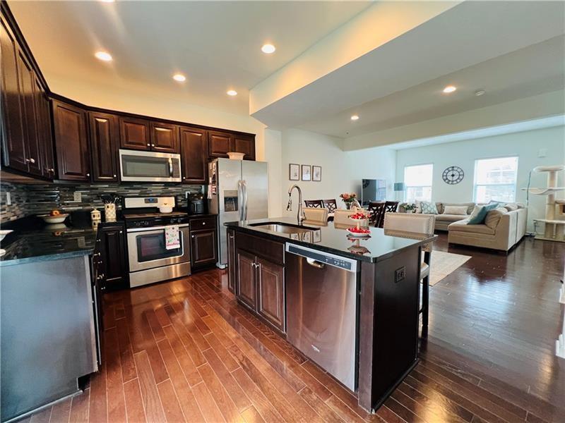 108 Watson Drive Warrendale, PA 15086 - Photo 13 of 31 a kitchen with stainless steel appliances kitchen island granite countertop a stove refrigerator and a microwave