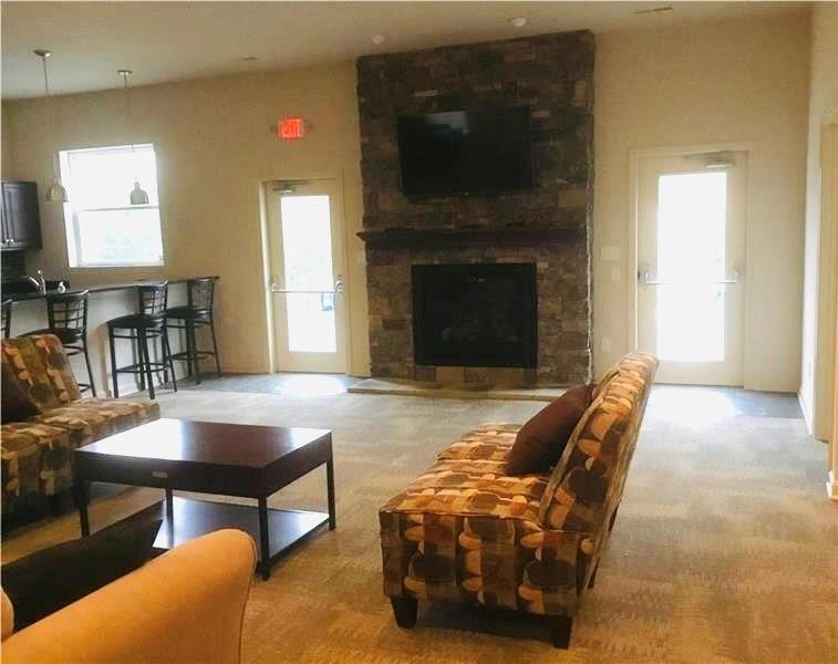 108 Watson Drive Warrendale, PA 15086 - Photo 31 of 31 a living room with furniture a flat screen tv and a fireplace