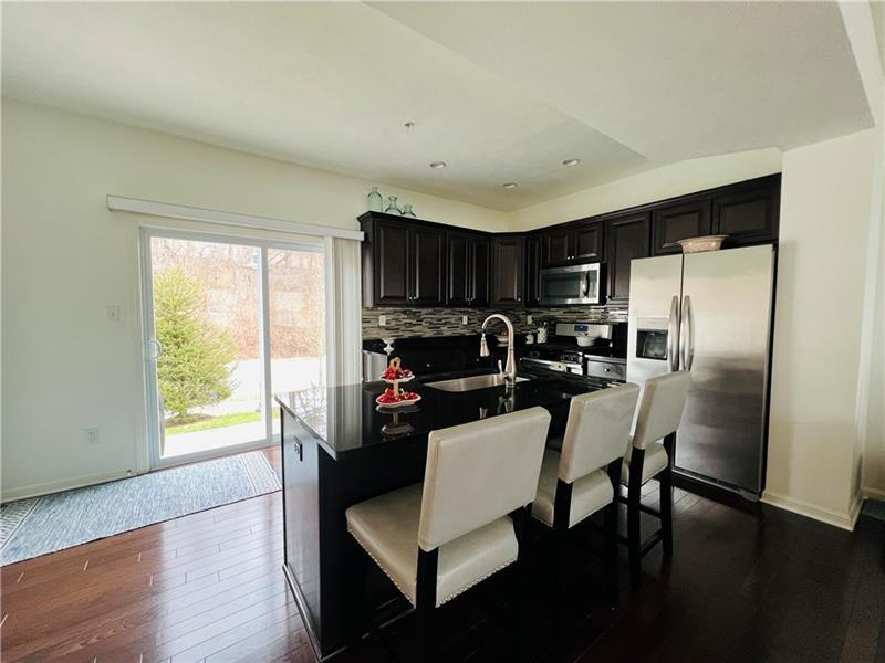 108 Watson Drive Warrendale, PA 15086 - Photo 10 of 31 a kitchen with a table chairs refrigerator and microwave