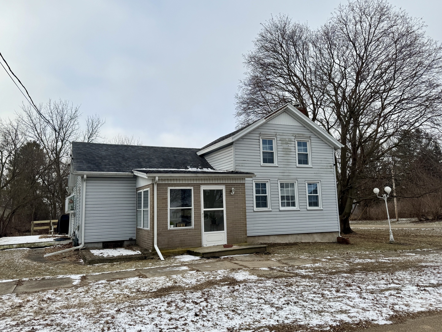 108 West Washington Street Dover, IL 61323 - Photo 2 of 28 a front view of a house with a tree