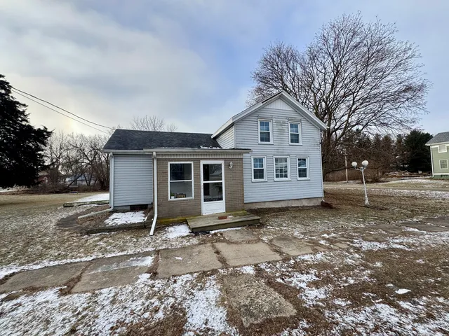 a view of a house with a yard covered in snow