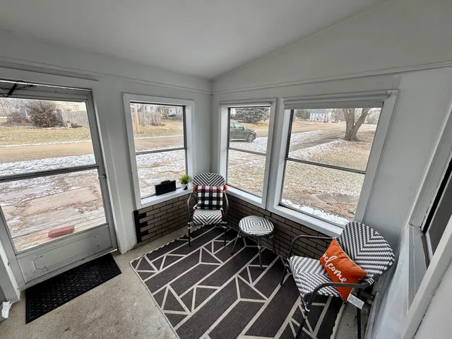 a living room with furniture and a floor to ceiling window