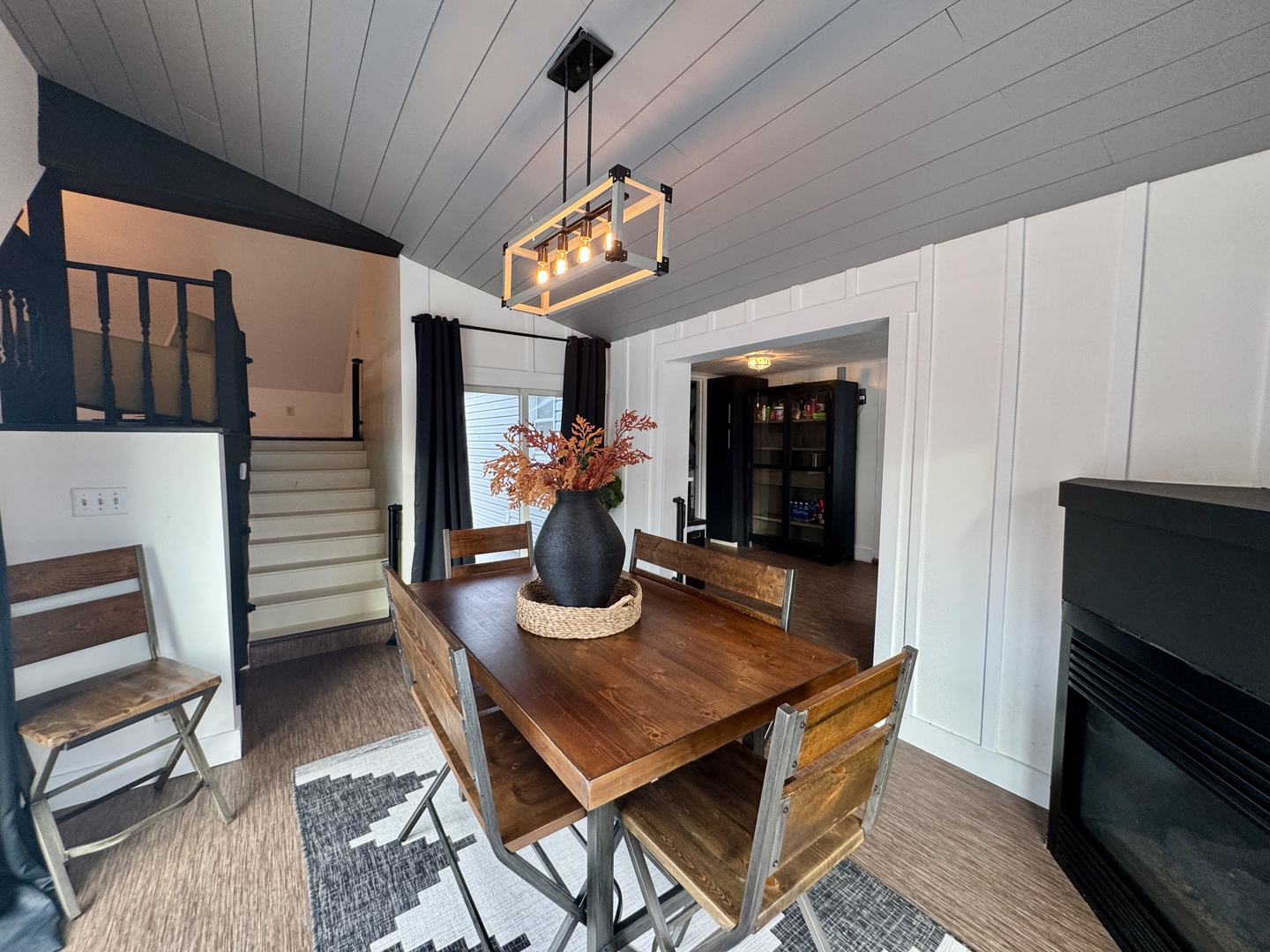 108 West Washington Street Dover, IL 61323 - Photo 9 of 28 a dining room with wooden floor a chandelier a wooden table and chairs