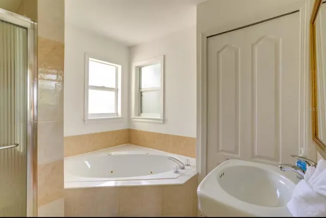 a white bath tub sitting next to a window