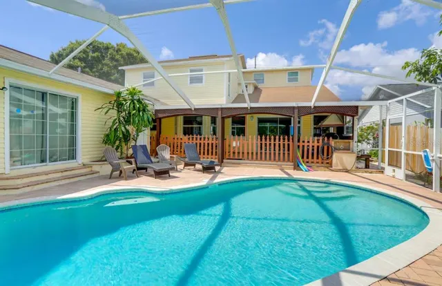a view of a house with backyard porch and sitting area