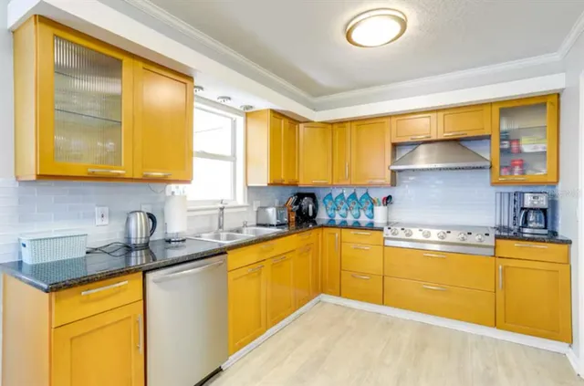 a kitchen with stainless steel appliances granite countertop a sink and cabinets