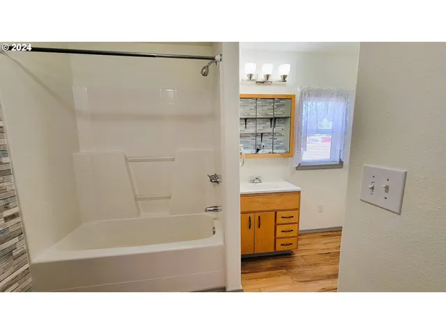 a view of house with backyard and pool