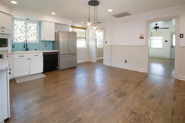 a large kitchen with cabinets and stainless steel appliances