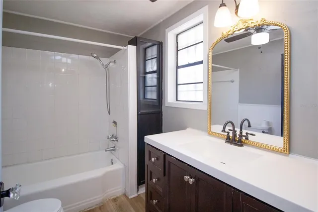 a view of washer and dryer with bathroom in the background