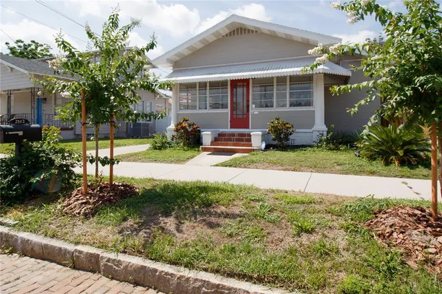 a view of a house with backyard and sitting area