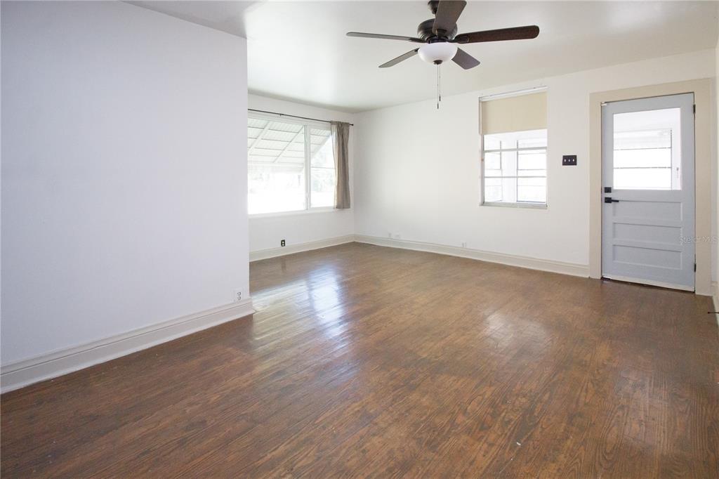 2512 West Cordelia Street Tampa, FL 33607 - Photo 6 of 19 an empty room with wooden floor ceiling fan and windows