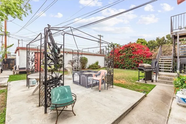 a backyard of a house with table and chairs