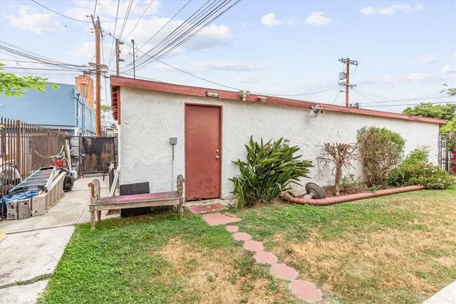 a view of a patio with table and chairs potted plants