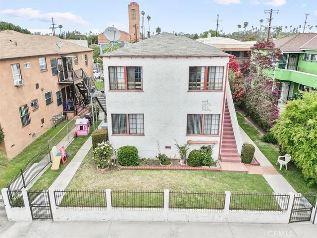 a aerial view of a house with a yard and potted plants