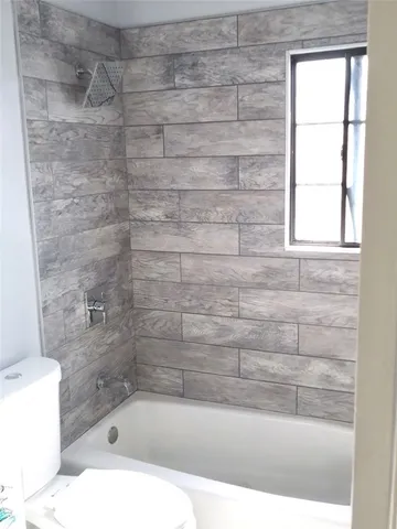 a bathroom with a shower and bathtub