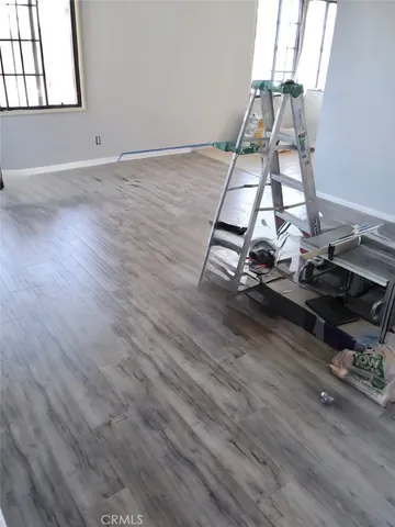 a room with wooden floor and window