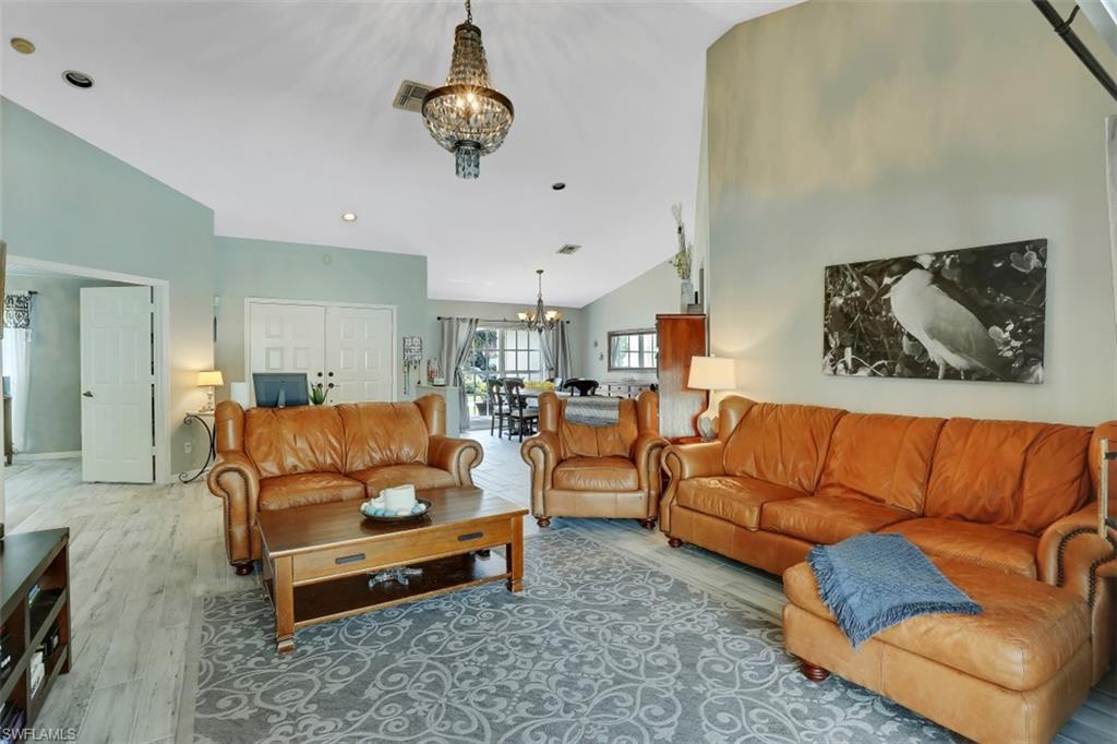 7359 Stonegate Drive Naples, FL 34109 - Photo 12 of 33 a living room with furniture ceiling fan and a rug