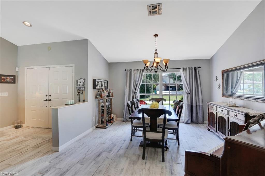 7359 Stonegate Drive Naples, FL 34109 - Photo 16 of 33 a view of a dining room with furniture window and wooden floor