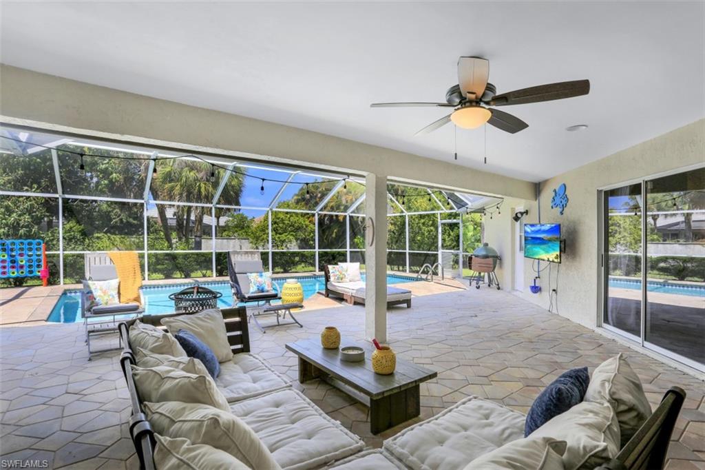 7359 Stonegate Drive Naples, FL 34109 - Photo 23 of 33 a living room with furniture and a large window