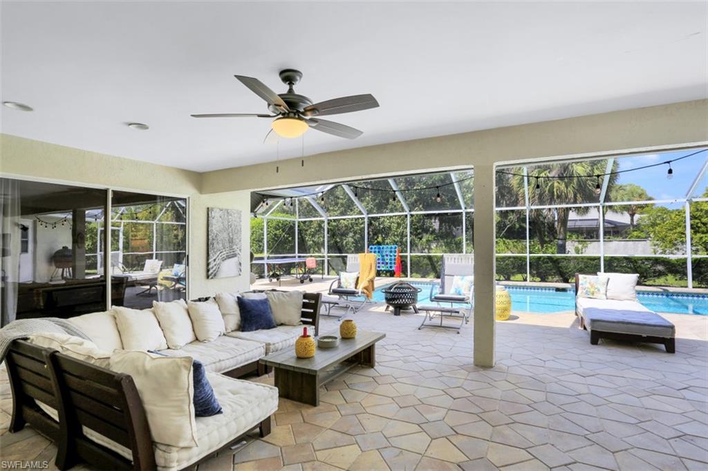7359 Stonegate Drive Naples, FL 34109 - Photo 24 of 33 a living room with furniture and a large window