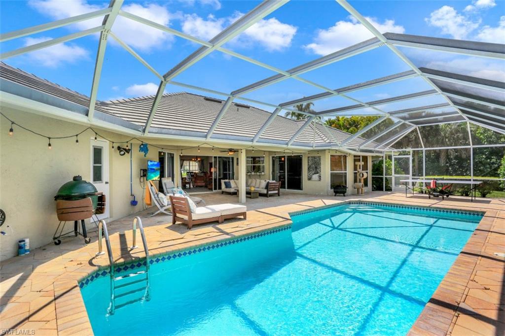 7359 Stonegate Drive Naples, FL 34109 - Photo 28 of 33 a view of a backyard with swimming pool and sitting area
