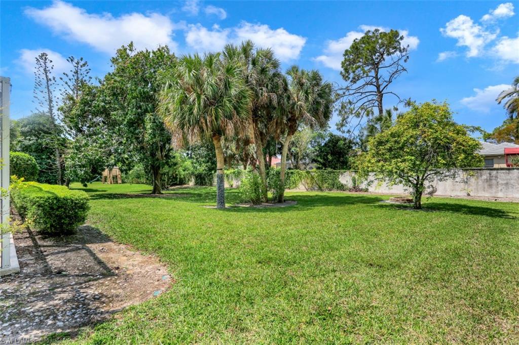 7359 Stonegate Drive Naples, FL 34109 - Photo 29 of 33 a view of a garden with a tree