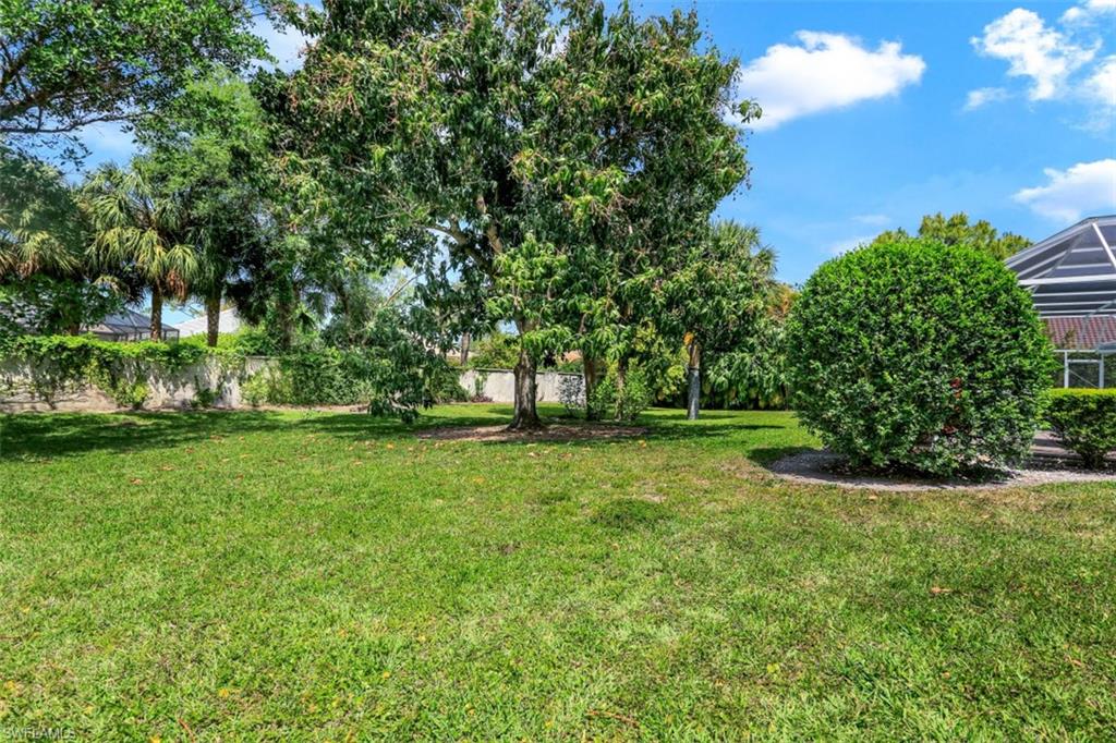 7359 Stonegate Drive Naples, FL 34109 - Photo 30 of 33 a view of a garden with trees