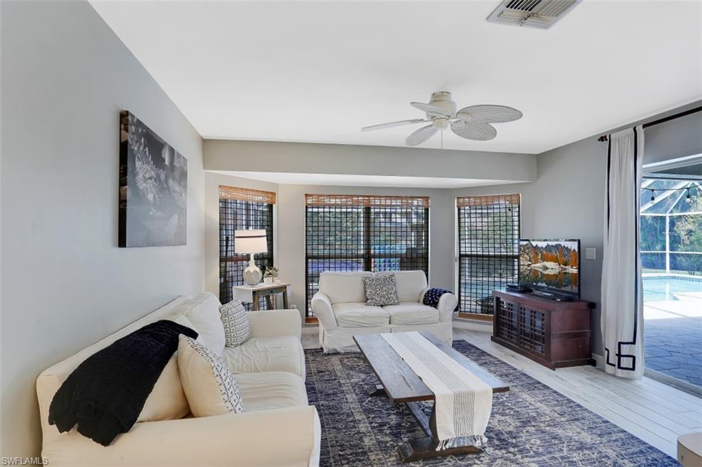 7359 Stonegate Drive Naples, FL 34109 - Photo 5 of 33 a living room with furniture and a flat screen tv