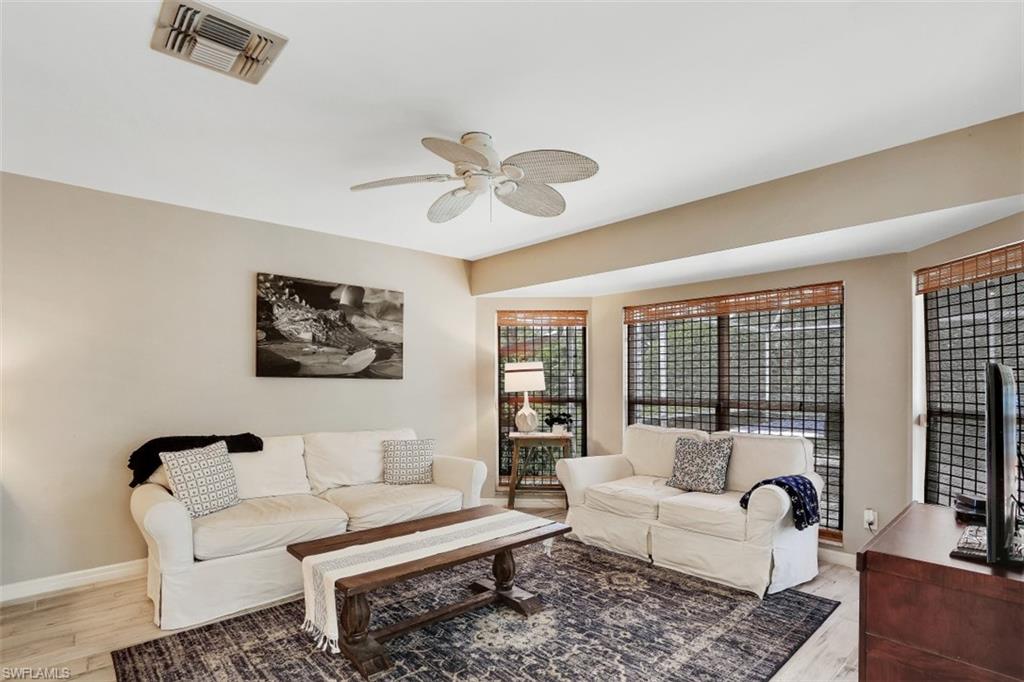 7359 Stonegate Drive Naples, FL 34109 - Photo 6 of 33 a living room with furniture and a large window